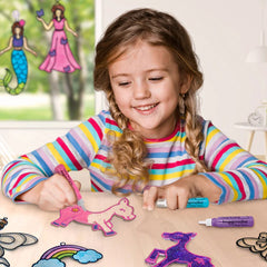 Child playing with colorful magnetic toys on a table, with mermaid and rainbow drawings in the background.