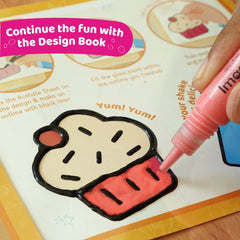 Hand using a pink marker to color a cartoon ice cream cone on a design book with text 'Continue the fun with the Design Book'.