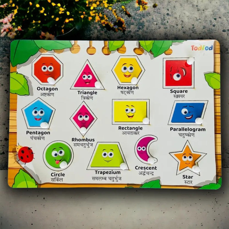 Educational children's board with geometric shape cards and cartoon faces on a textured surface.