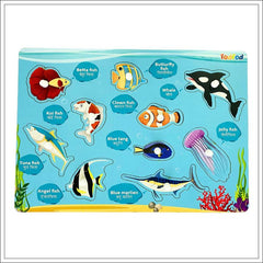 Educational toy with ocean-themed puzzles and labels on a blue background