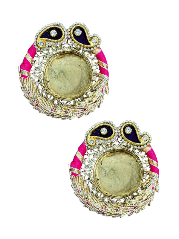 Decorative earrings with pink and gold accents on a white background