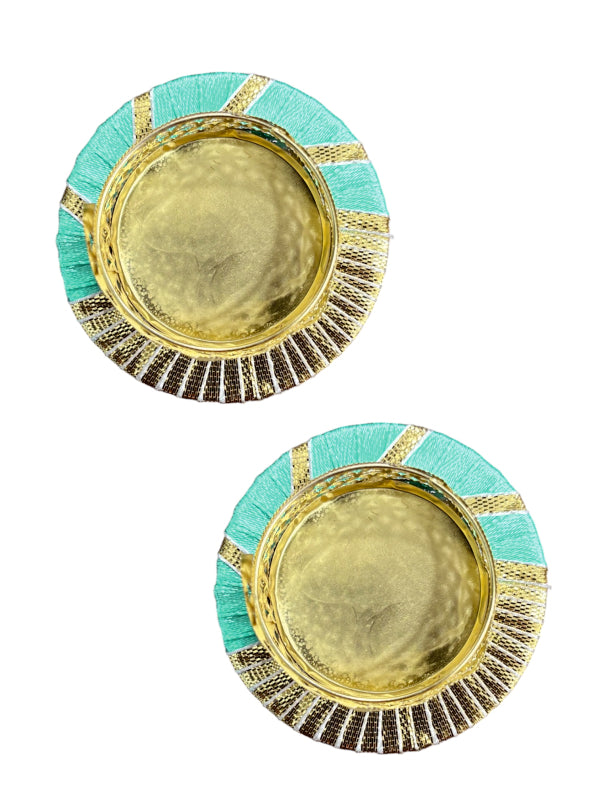 Pair of round earrings with gold center and green border on a white background