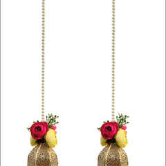 Two decorative hanging lanterns with floral elements on a white background