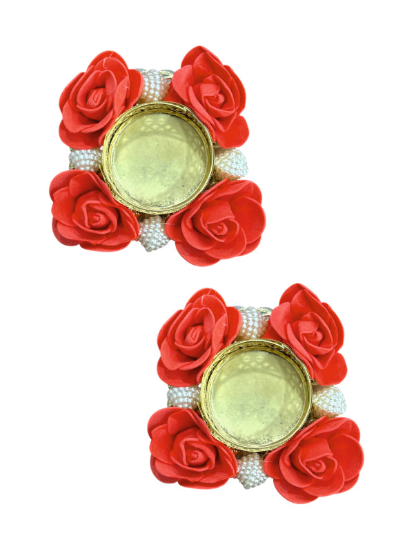 Pair of earrings with red rose petals and pearl-like beads on a white background