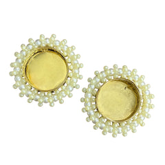 Pair of earrings with yellow center and green beadwork on a white background