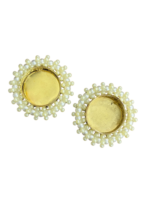Pair of earrings with yellow center and green beadwork on a white background