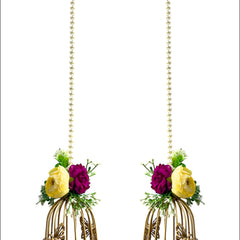 Pair of decorative earrings with floral elements and gold cage design on a white background