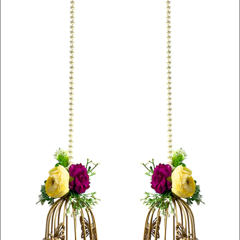 Pair of decorative earrings with floral elements and gold cage design on a white background