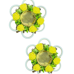 Pair of floral earrings with green and yellow stones on a white background