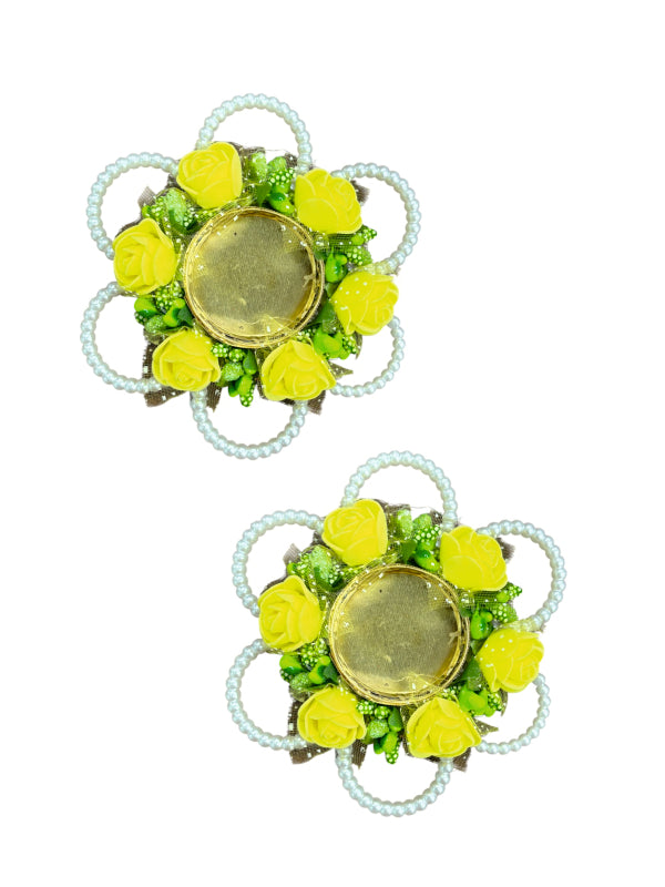 Pair of floral earrings with green and yellow stones on a white background