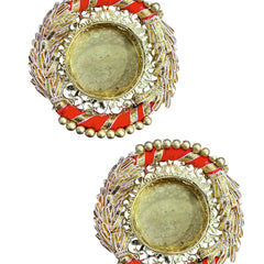 Pair of decorative earrings with red and gold accents on a white background