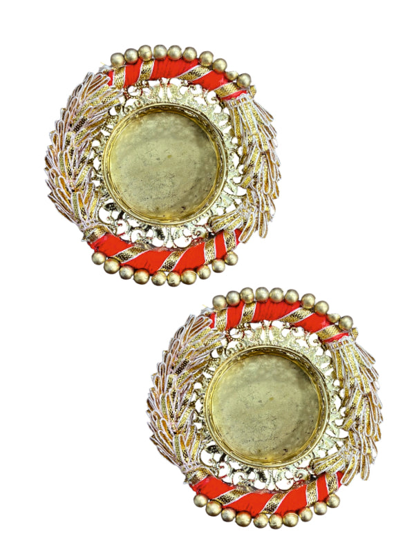 Pair of decorative earrings with red and gold accents on a white background