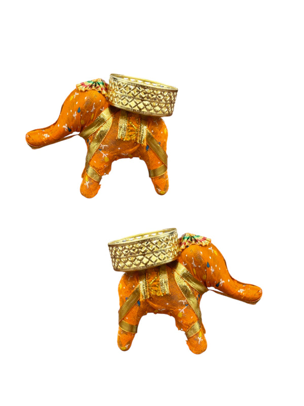 Two decorative elephant figurines with gold baskets on a white background