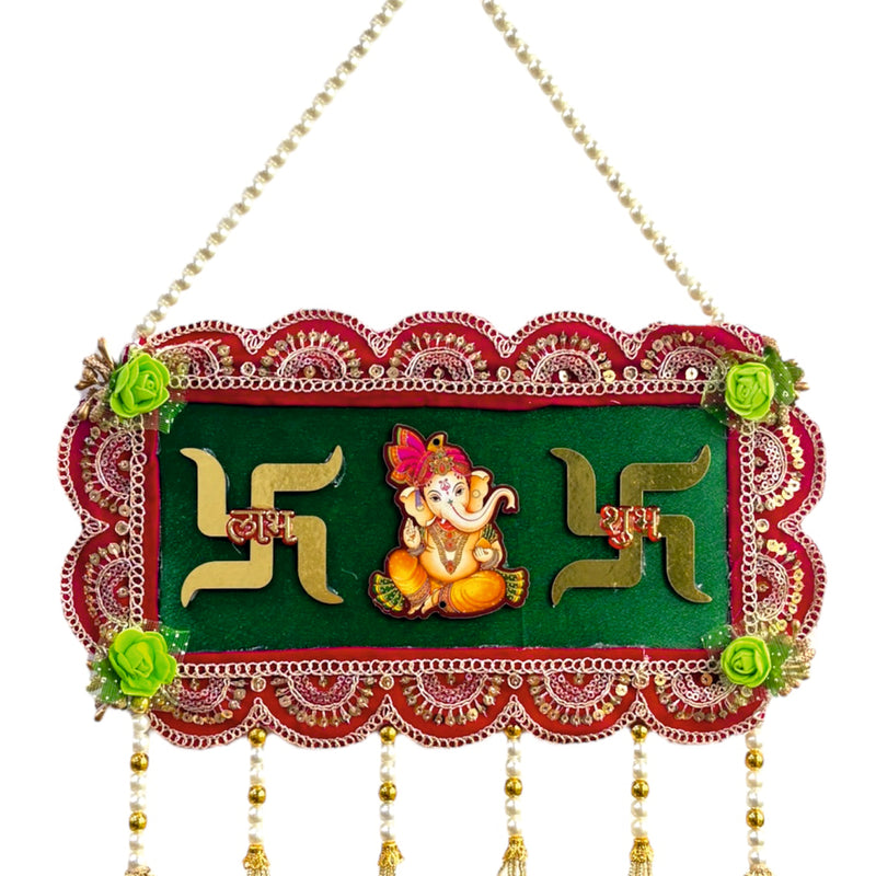 Decorative wall hanging with Swastika design and Lord Ganesha on a green background.
