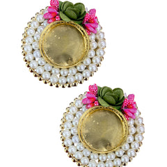 Pair of earrings with pearl-like beads and floral decorations on a white background