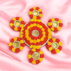 Decorative design made of red, yellow, and gold flowers on a pink background