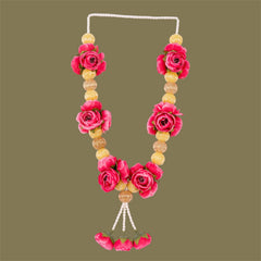 Necklace with pink floral and yellow bead design on a green background
