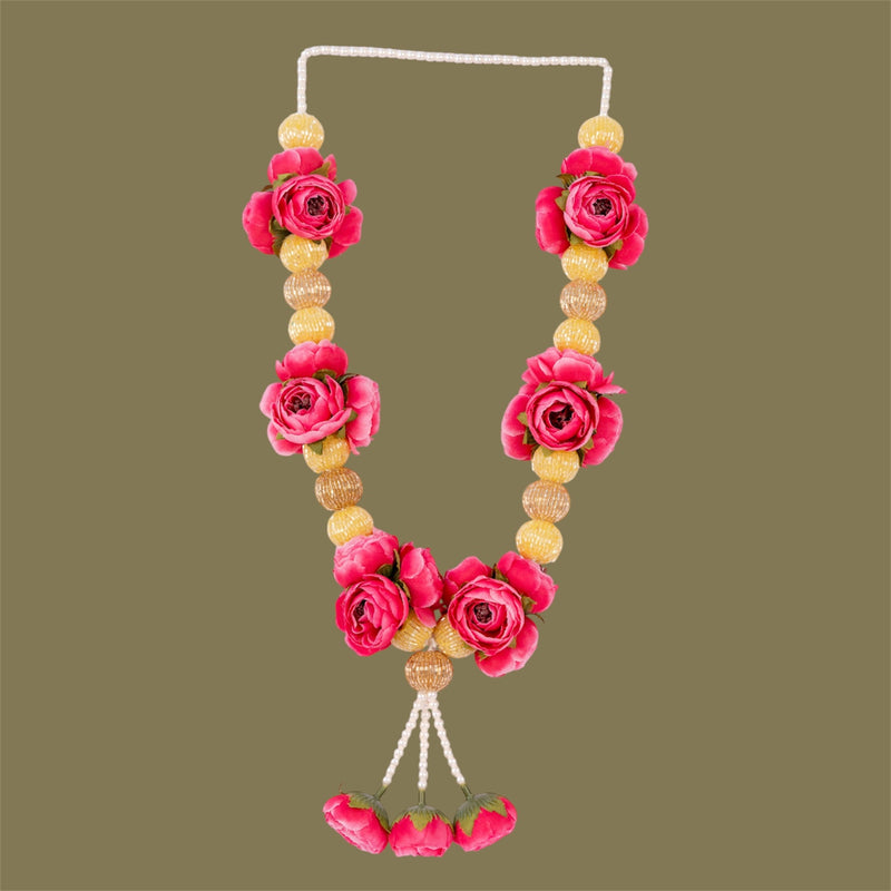 Necklace with pink floral and yellow bead design on a green background