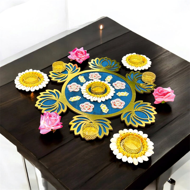 Decorative rangoli design on a black surface with colorful flowers.