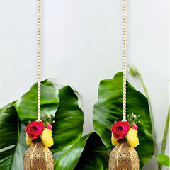 Two decorative hanging lanterns with floral elements on a green leaf background
