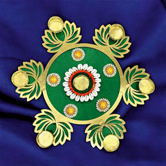 Decorative rangoli design on a blue fabric background