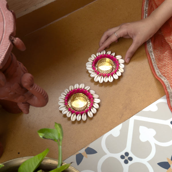 Decorative oil lamps with floral designs on a wooden surface.