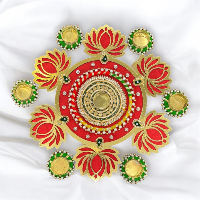 Decorative red and gold circular design with floral elements on a white background