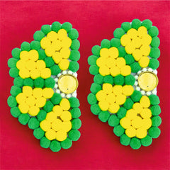Green and yellow flip-flop sandals on a pink background