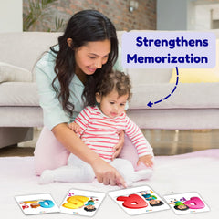 Woman and child playing with educational cards on a couch