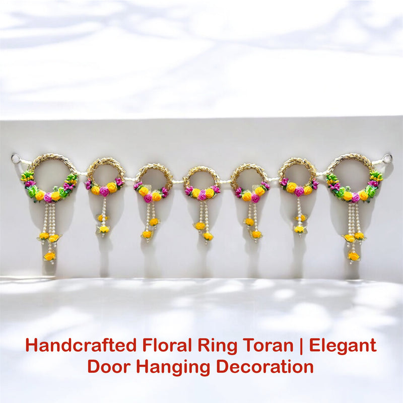 Handcrafted floral ring toran with colorful beads on a white background