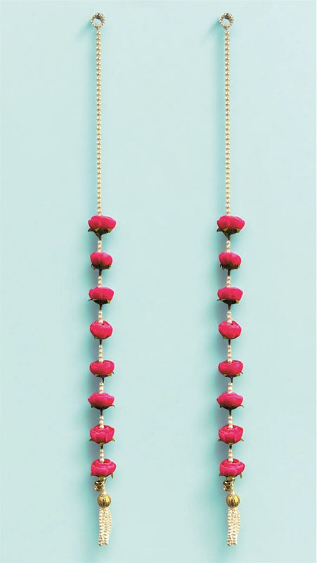 Two long necklaces with pink beads and gold chains on a light blue background