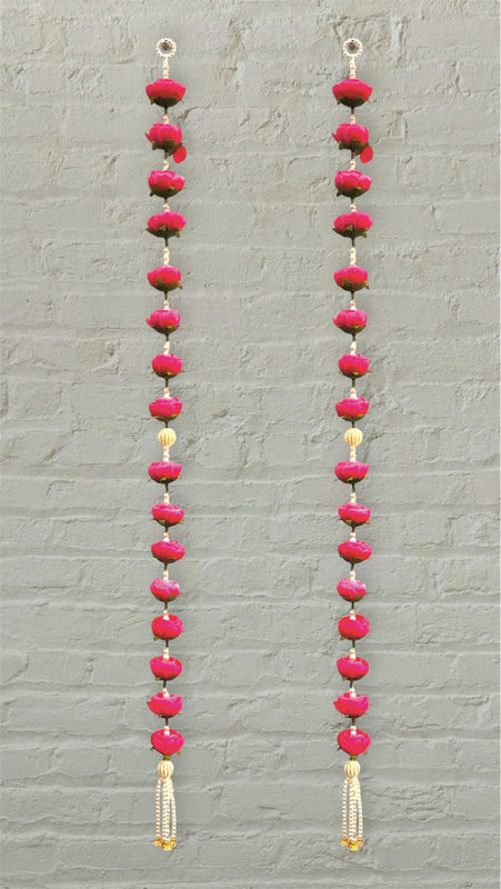 Long earrings with pink and red beads on a gray background