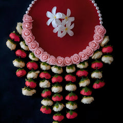 Decorative Laddu Gopal Pooja Thali with Lotus Hangings on a dark background