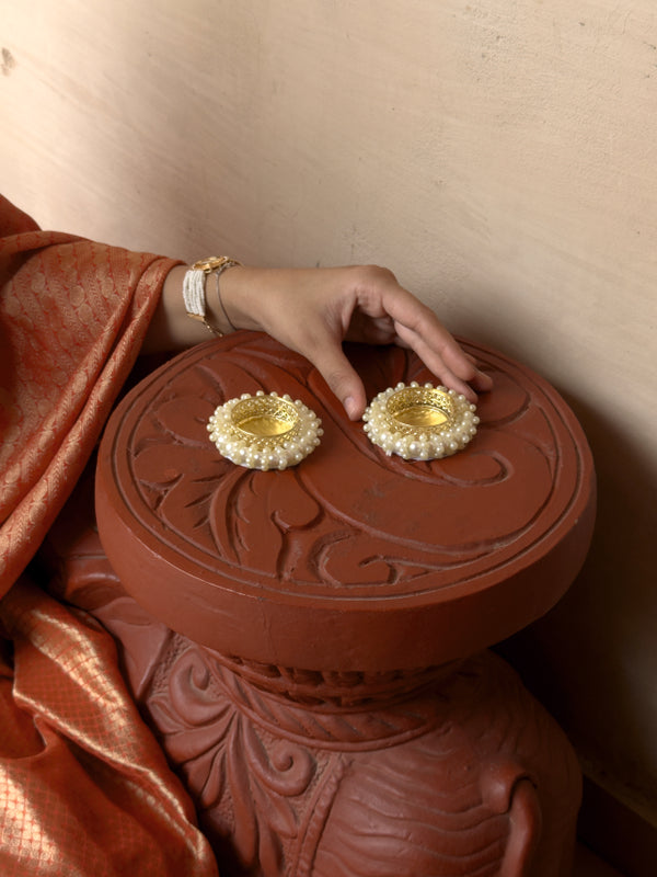 Person holding a red decorative box with gold embellishments