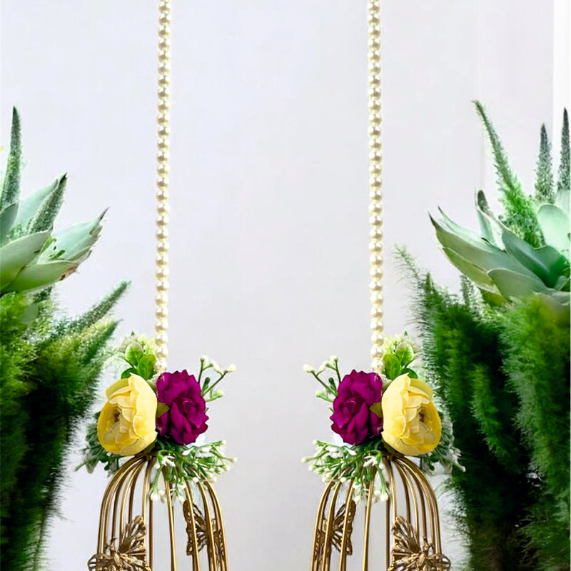 Two decorative hanging birdcages with flowers against a white background