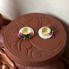 Pair of earrings on a decorative brown box