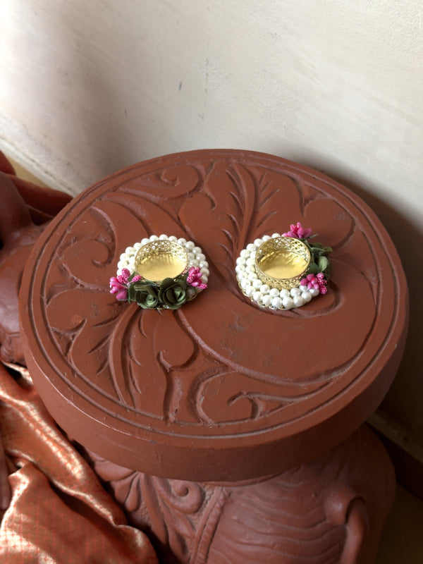Pair of earrings on a decorative brown box