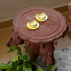 Decorative red stand with gold elements on a patterned floor