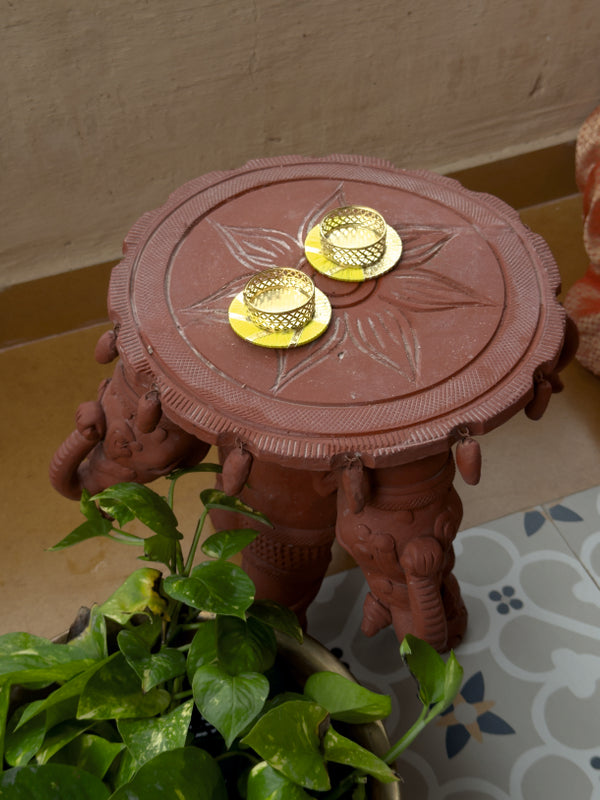 Decorative red stand with gold elements on a patterned floor