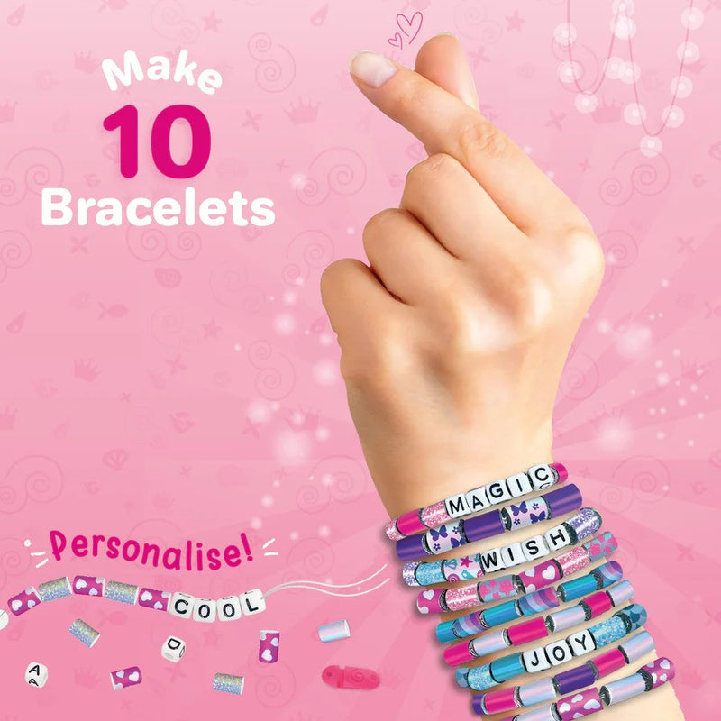 Hand wearing multiple bracelets with customizable charms on a pink background
