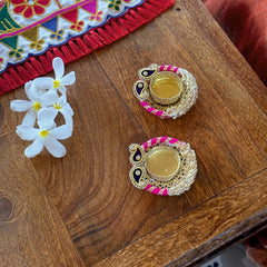 Decorative items on a wooden surface with flowers and colorful fabric.