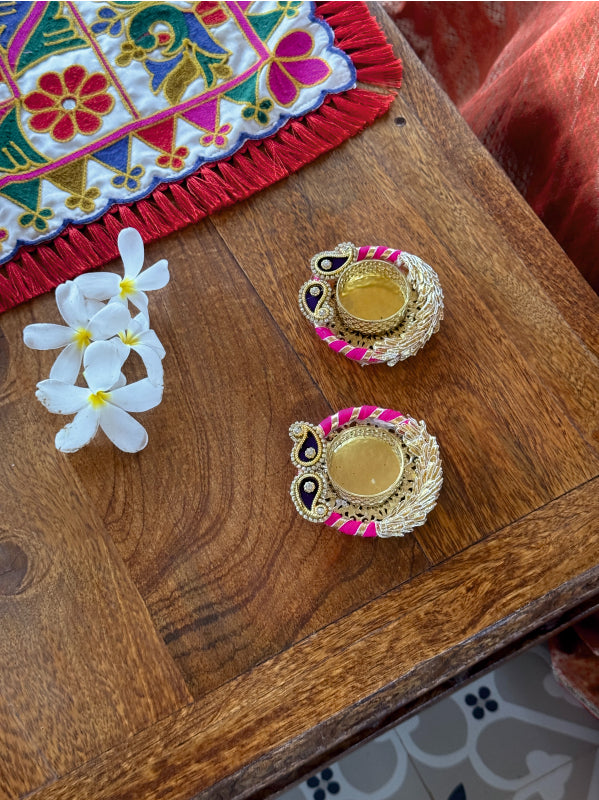 Decorative items on a wooden surface with flowers and colorful fabric.