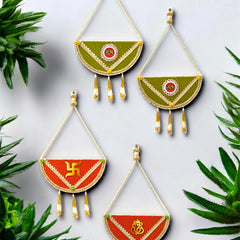 Decorative wall hangings with green and red designs on a light gray background with green plants.