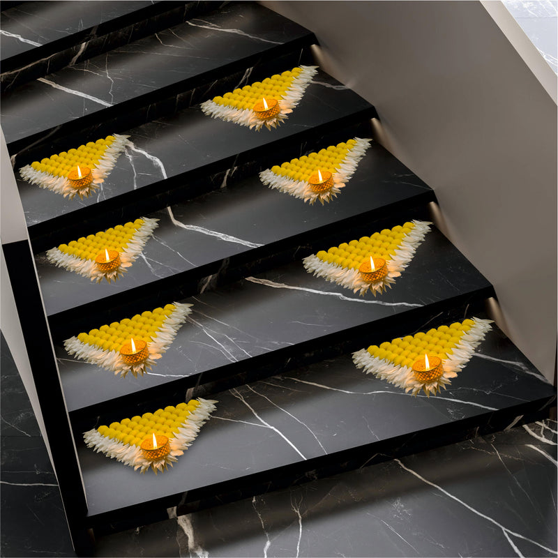 Decorative steps with yellow flower petals and candles on a marble staircase.