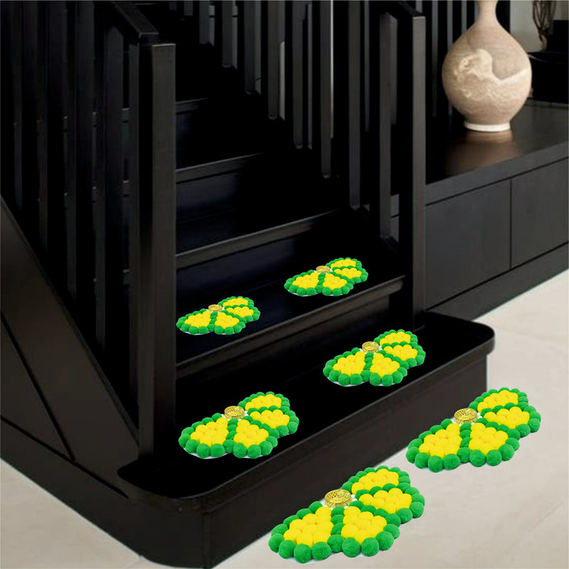 Green and yellow decorative items on a black staircase