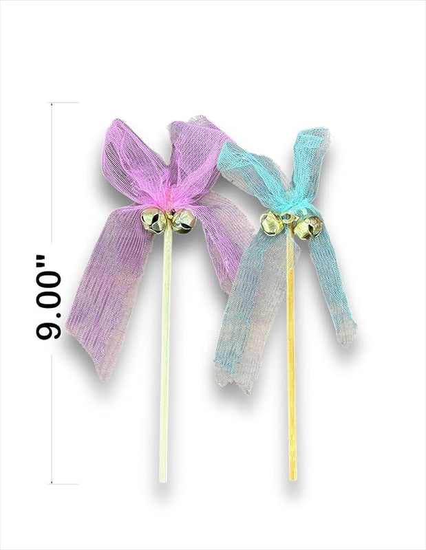 Two decorative bows on sticks with bells, one pink and one blue, on a white background.