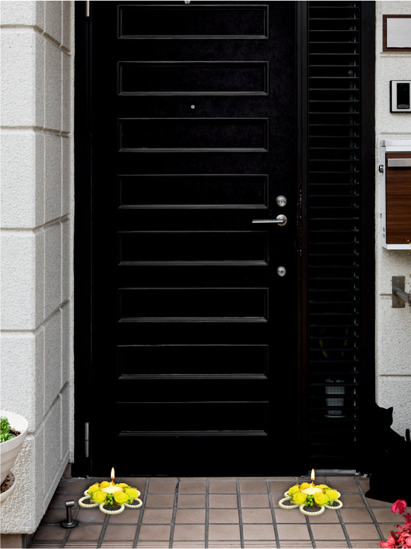 Black door with decorative elements on a stone pavement