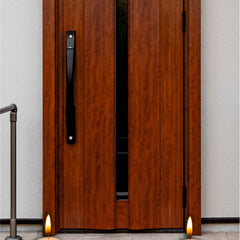 Wooden door with candles and floral arrangements on a pavement