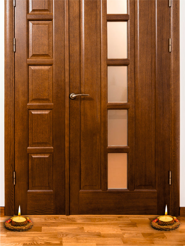 Wooden door with glass panels and candles on a wooden floor