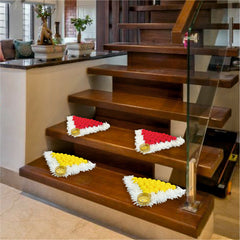 Decorative flower arrangements on a set of wooden stairs in a home setting.